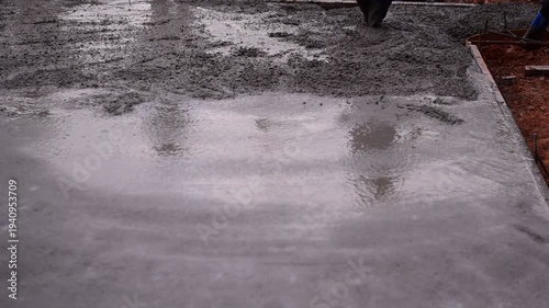 Pouring ready-mixed concrete onto reinforcing bars, We are pouring concrete on reinforced steel for the foundation