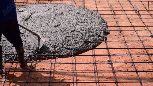 Pouring ready-mixed concrete onto reinforcing bars, We are pouring concrete on reinforced steel for the foundation