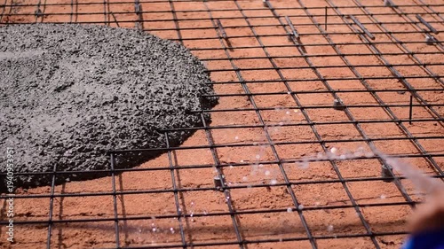 Pouring ready-mixed concrete onto reinforcing bars, We are pouring concrete on reinforced steel for the foundation