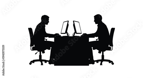 Two individuals working on computers facing each other in a silhouette