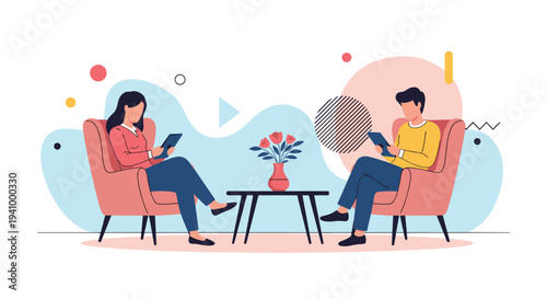 Man and woman sitting in comfortable chairs and focusing on their digital tablets with a vase of flowers between them.