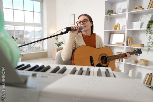 Young female musician singi...