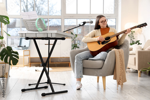 Young female musician playi...