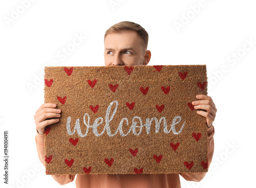 Young man with doormat on w...