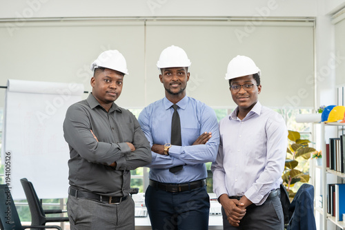 Waist up portrait of three black male engineer standing in office