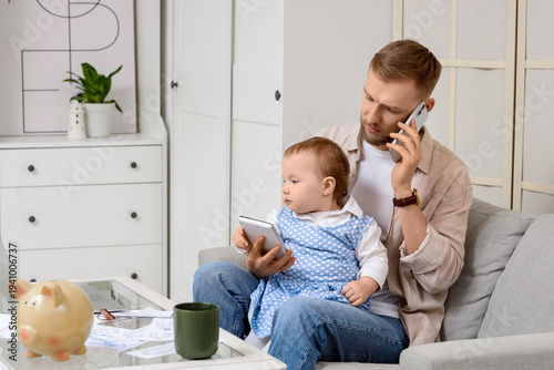 Young father with calculato...