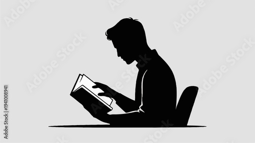 Silhouette of a person sitting cross legged reading a book in a relaxed pose on the floor