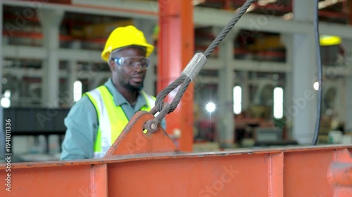 The engineers actively monitor the production line in a metal sheet factory. A male and engineer are checking the working.