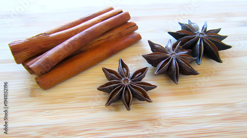 Cinnamon sticks and star anise on wooden cutting board for baking