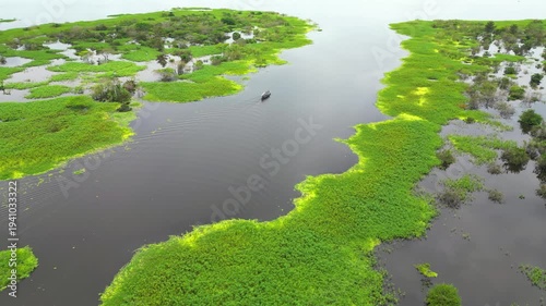 High-resolution aerial view of the riverfront boulevard in Iquitos featuring colorful historic buildings, vibrant urban streets, and a scenic promenade along the majestic Amazon River