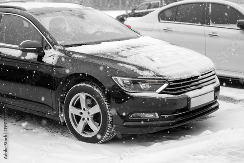 Black car with snow in city...