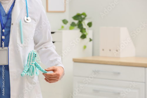 Male pediatrician with toy in his pocket at hospital