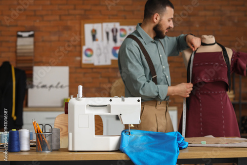Fashion designer measuring ...