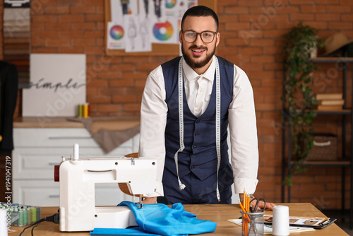Male tailor with sewing mac...