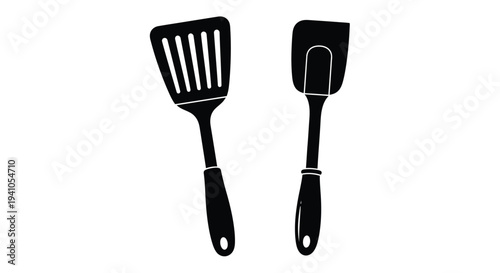 Black and white illustration of a slotted and solid spatula