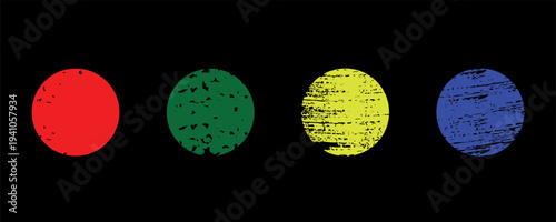 A series of four colored grunge ovals on a black background with red green yellow and blue hues