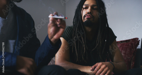 Fotografie Man, thinking or smoking weed with friends in home for stress relief, trippy or cannabis joint on 420
