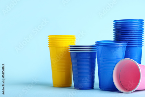 Colorful plastic cups on bl...