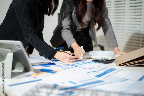 Business people meeting at office writing notes about sticky notes Laptop,tablet Planning and Brainstorming Strategies of Colleagues