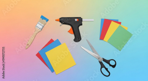Crafting tools and colorful paper on a rainbow background for diy projects and art