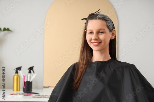 Young woman dyeing her hair...