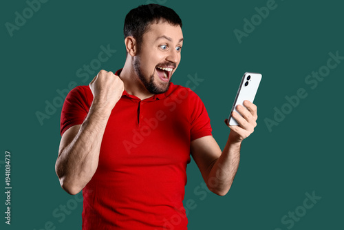 Happy young man with mobile...