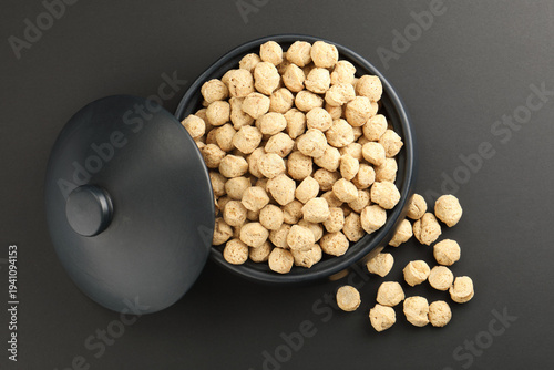 Raw soya chunks on  background. Healthy, nutritious soybean meat, chunks Vegan food concept.  known as soya wadi or meal maker in India 