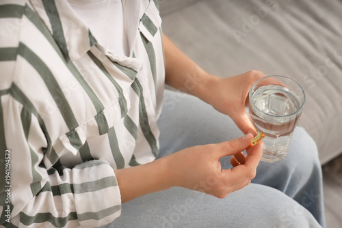 Woman with vitamin E pill a...