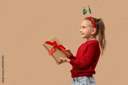 Cute little girl with gift ...