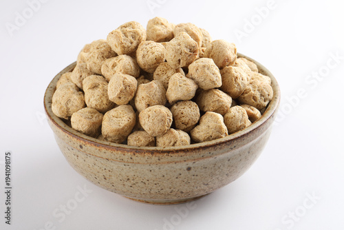 Raw soya chunks on  background. Healthy, nutritious soybean meat, chunks Vegan food concept.  known as soya wadi or meal maker in India 