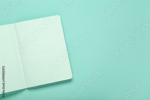 Blank notebook on turquoise...