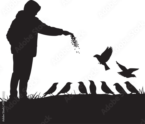 Silhouette of person feeding birds in winter landscape