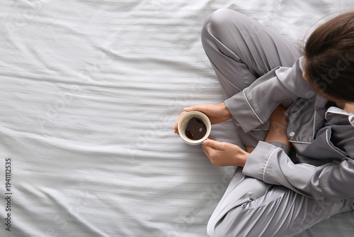 Young woman in pajamas with...