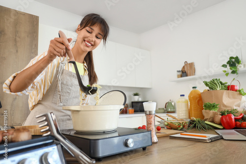 Young woman making noodle s...