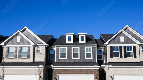 Bild auf Leinwand Modern residential townhouses under clear blue sky
