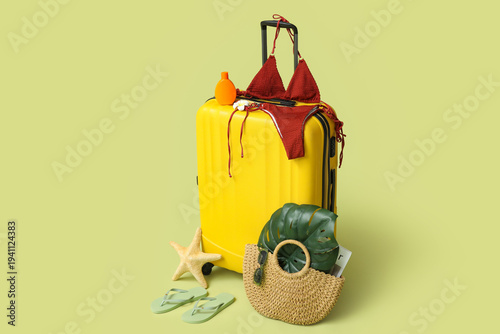 Yellow suitcase with stylis...
