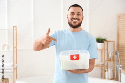 Young man pointing at first...