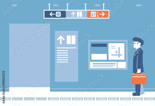 駅の通路を歩くスーツ姿の男性
