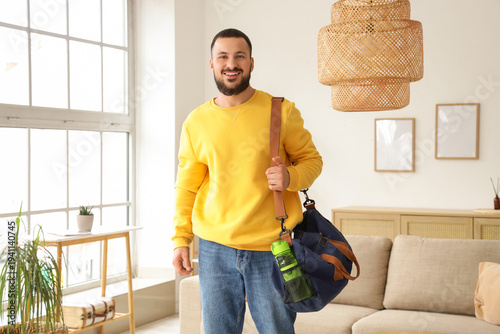 Young man with sports bag a...