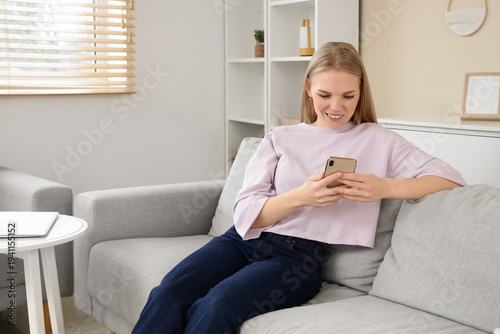 Young blonde woman using mo...