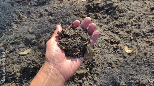 4K slow-motion video shows hand scooping up handful of black organic soil gently squeezing and releasing it for analysis. Perfect for projects highlighting gardening agriculture environmental care