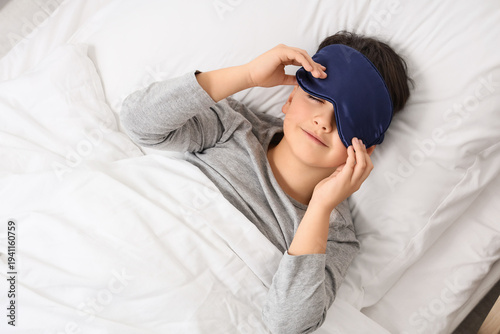 Cute boy in sleeping mask l...