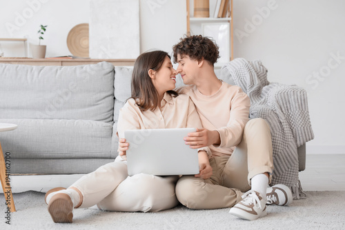 Young couple with laptop ki...