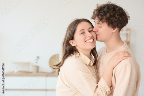 Young man kissing his girlf...