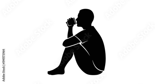 Silhouette of a person enjoying a quiet drink while sitting on the ground in solitude