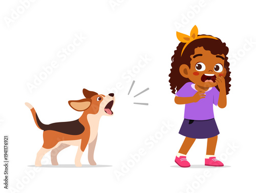 A barking dog scares an African American little girl who looks surprised and afraid with wide eyes