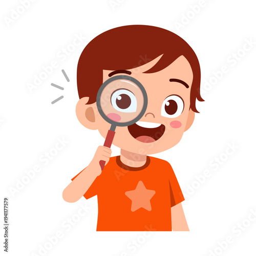 Happy curious boy with magnifying glass looking playfully smiling broadly with an orange star shirt