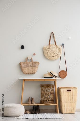 Interior of hall with coffee table, baskets, pouf and wicker bags