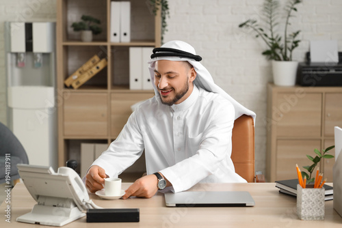 Arab businessman with cup o...
