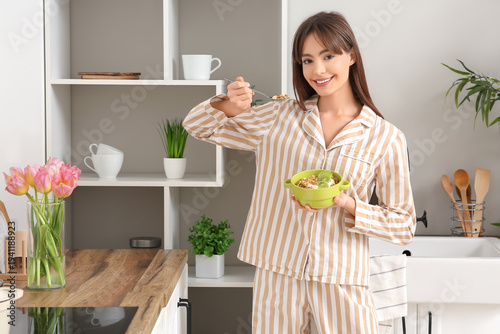Young woman eating tasty gr...